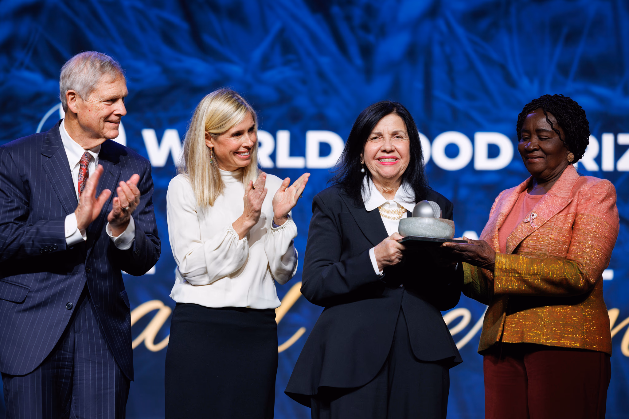 A photo of the World Food Prize laureate holding the award at the Laureate Award Ceremony