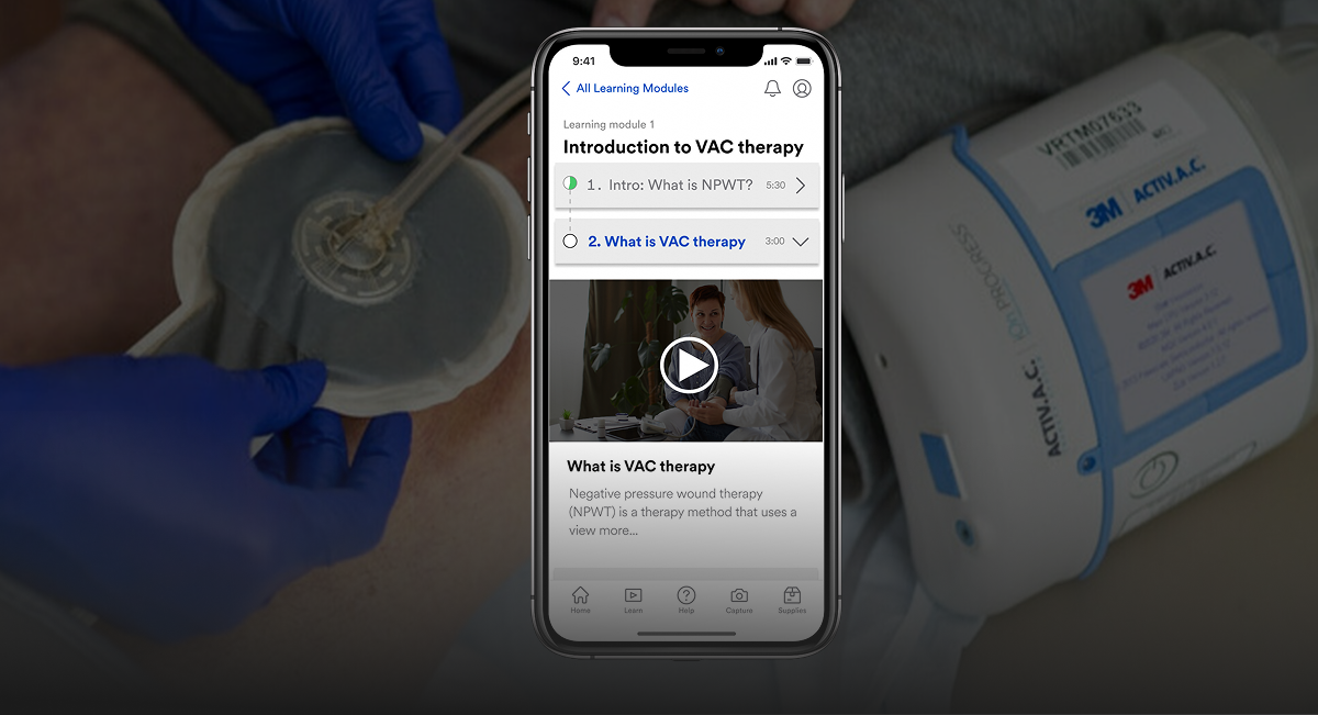 A wound education mobile app screen with a negative wound therapy machine on the background